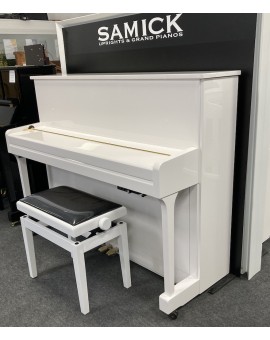 Small white study piano with silencer